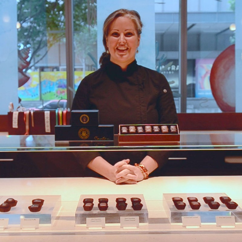 a person sitting at a table in front of a window