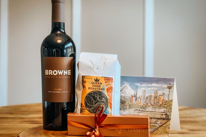 a bottle of wine sitting on top of a wooden table