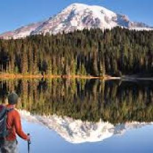 a man standing on top of a snow covered mountain