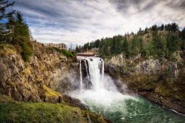 a large waterfall over a body of water with Snoqualmie Falls in the background
