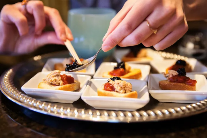 a woman sitting at a table with a plate of food