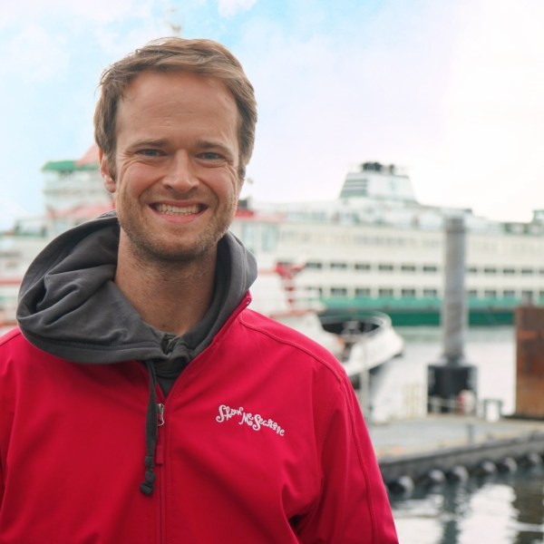 a man standing in front of a body of water
