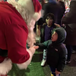 a little girl standing in front of a crowd