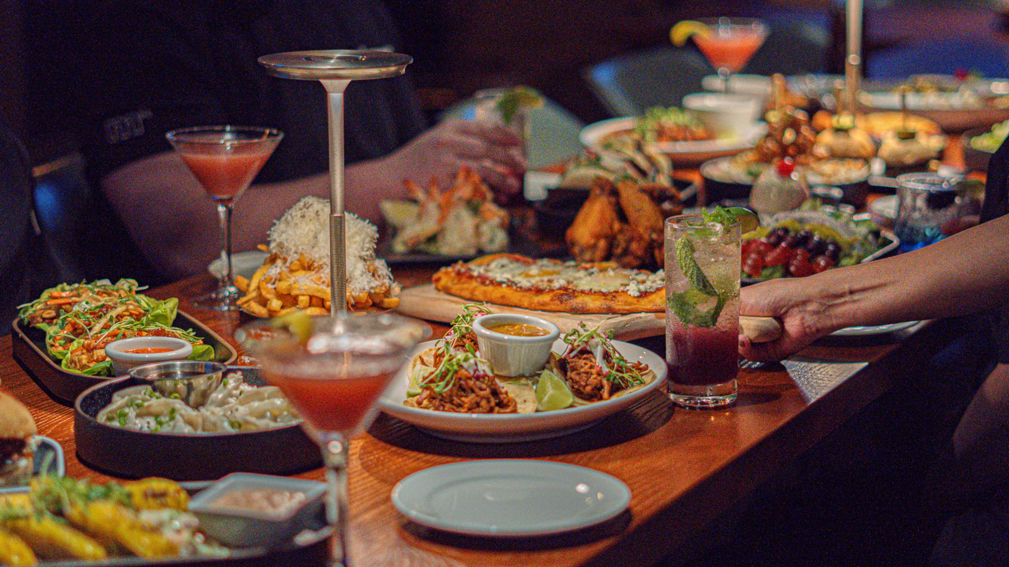 a group of people sitting at a table full of food