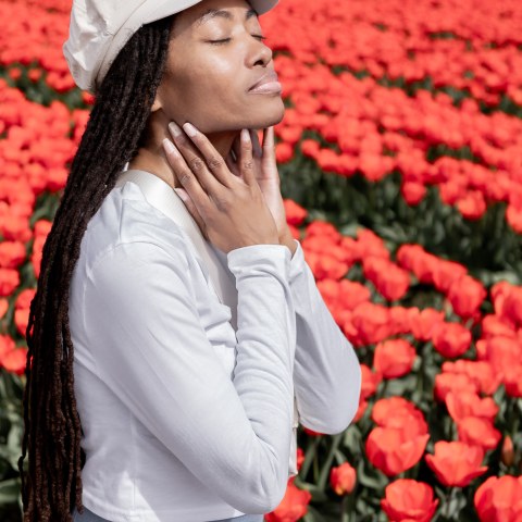 a woman wearing a hat talking on a cell phone