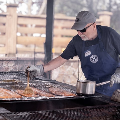 a man sitting on a grill