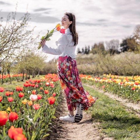 a little girl flying a kite in a field