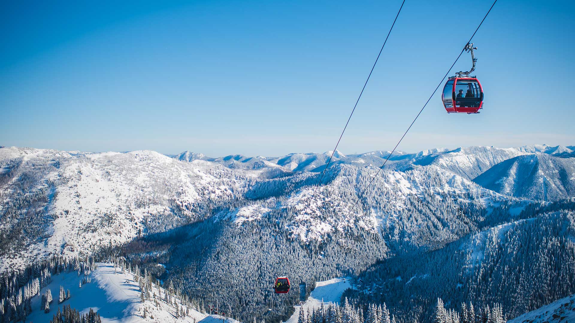 a man flying through the air on a snow covered mountain