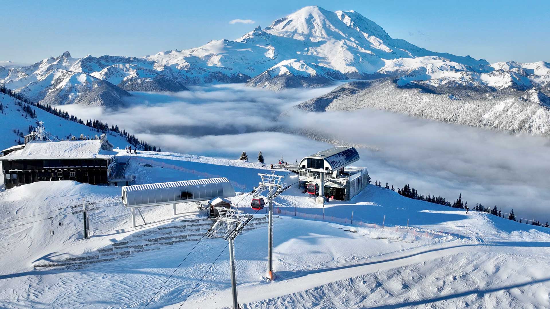 a man standing on top of a snow covered mountain