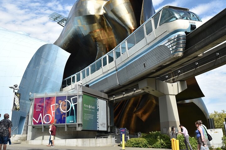 a statue of a person with Museum of Pop Culture in the background