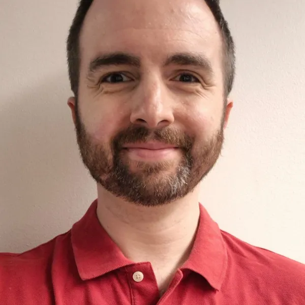 a man wearing glasses and looking at the camera